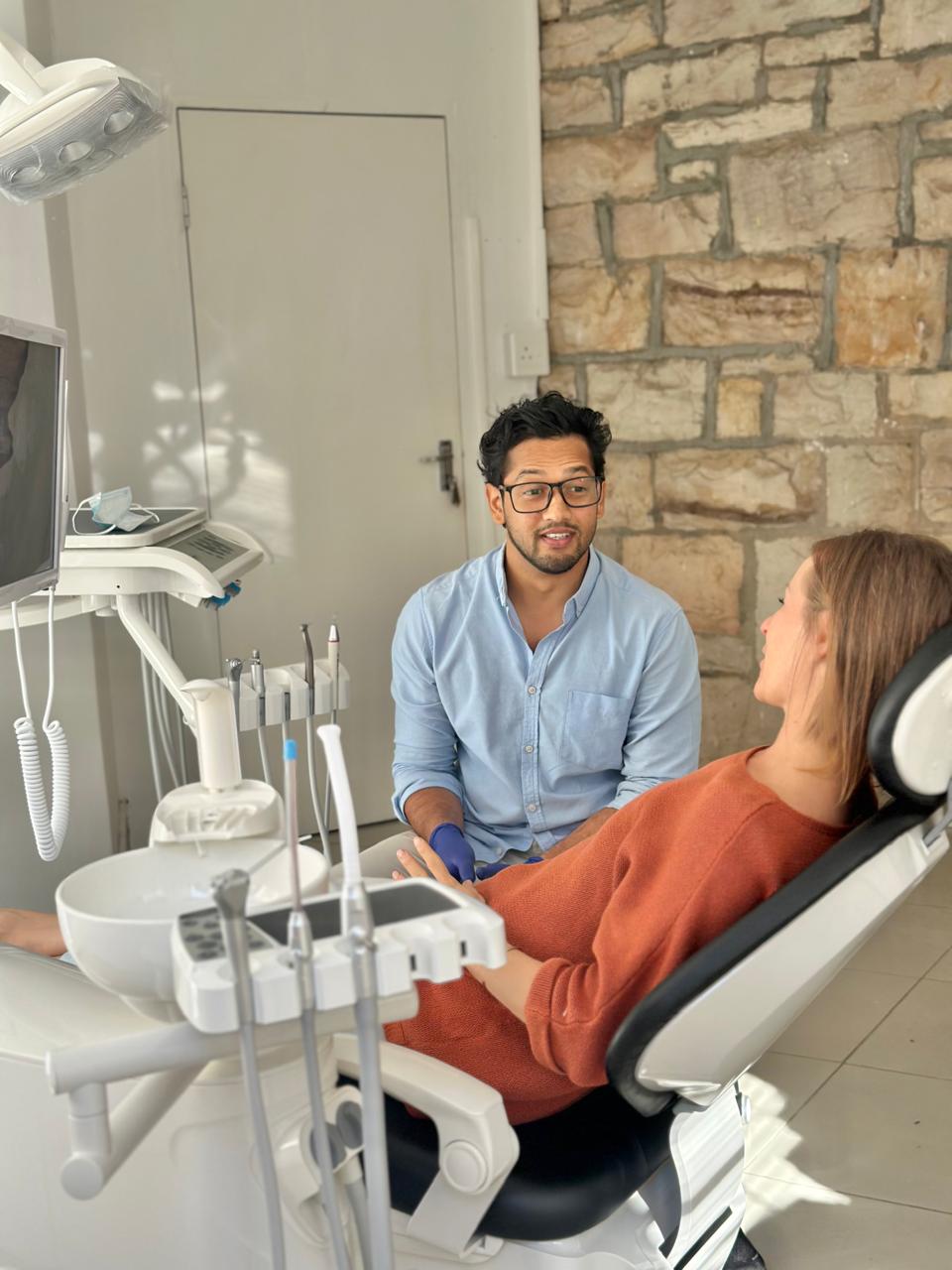 Dr. Reddy talking with a patient before treatment